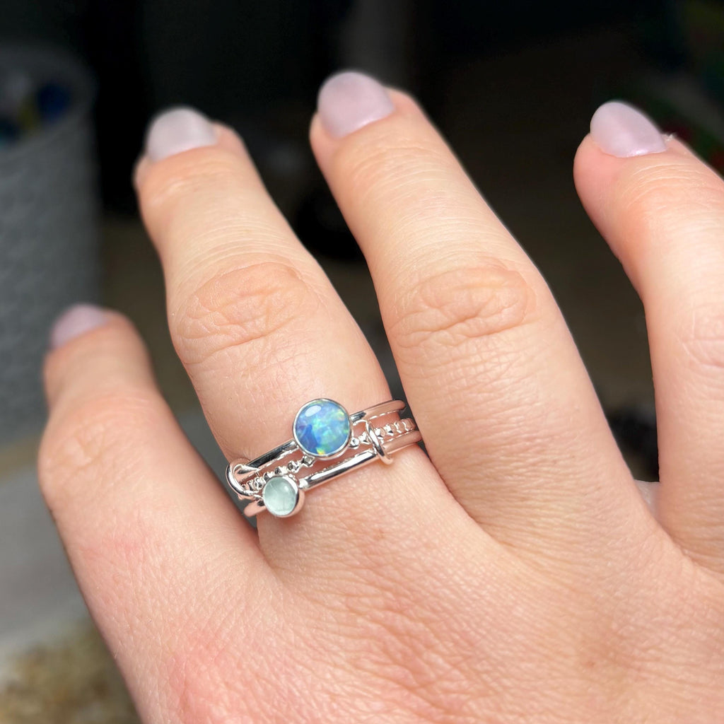 Opal and aquamarine interlocking ring