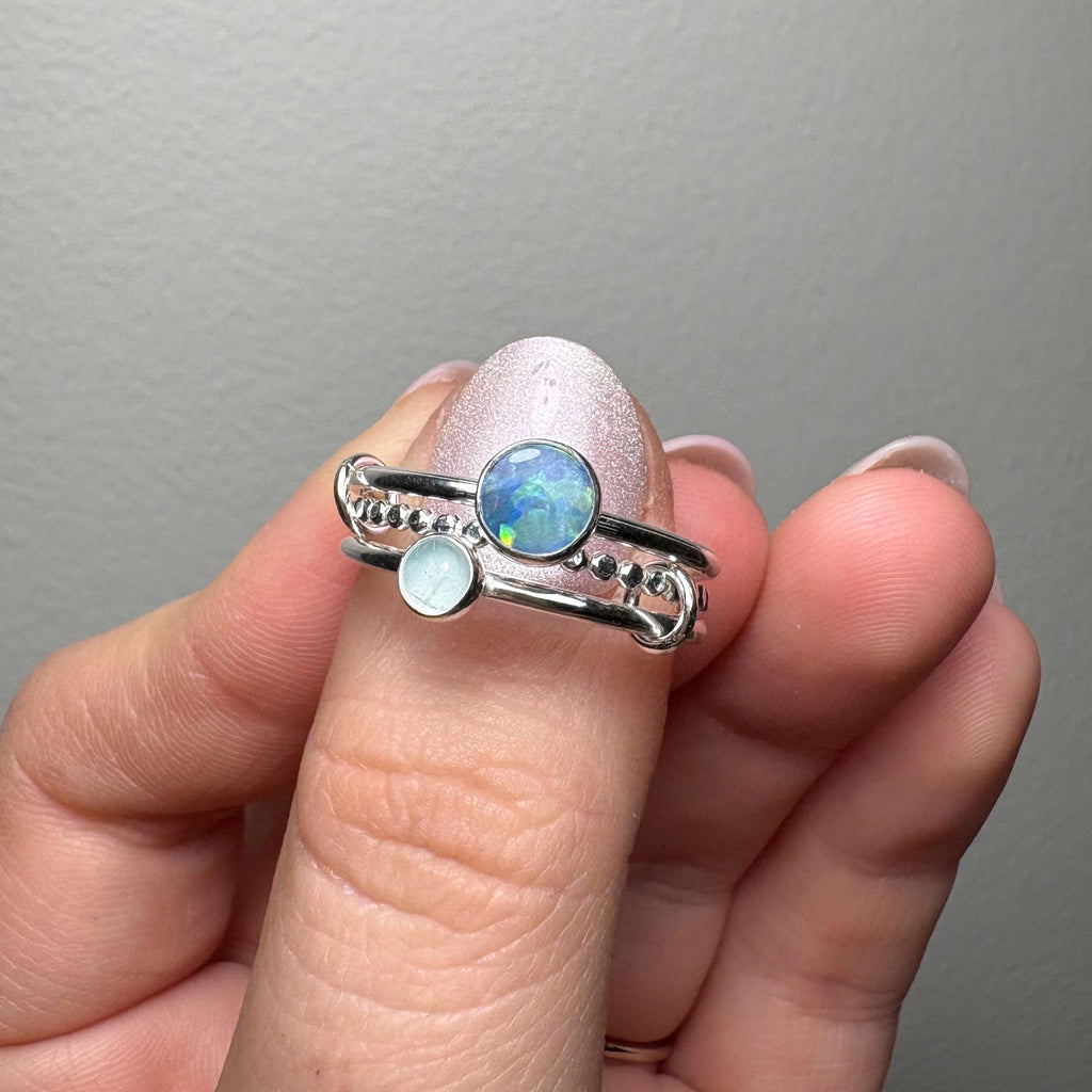 Opal and aquamarine interlocking ring