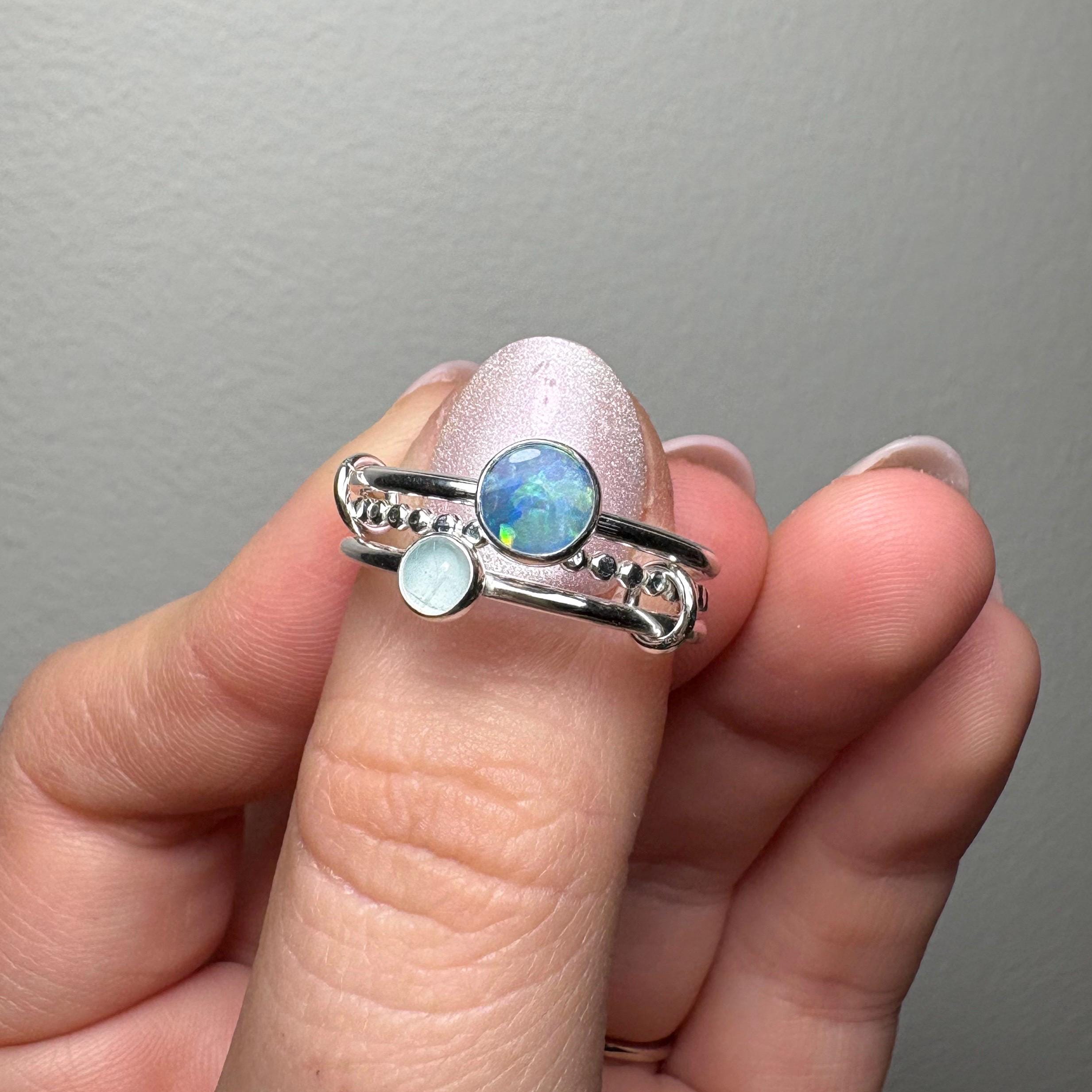 Opal and aquamarine interlocking ring